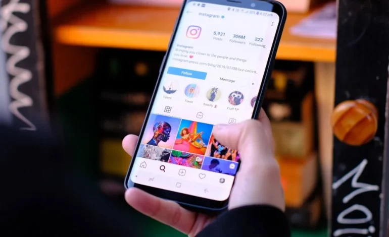 a-person-holding-up-smartphone-with-Instagram-on-it